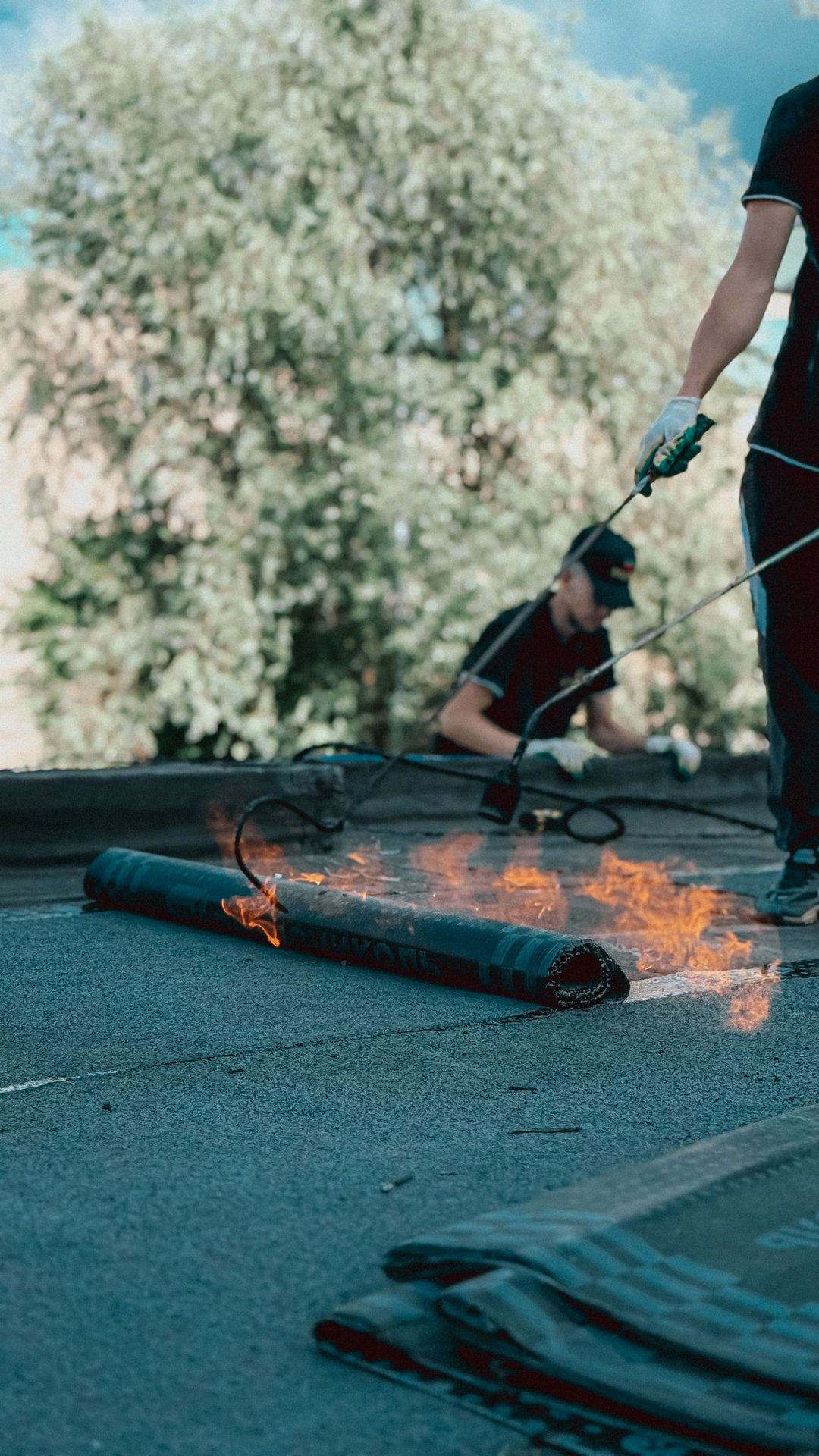 Roofer installing membrane on a flat roof